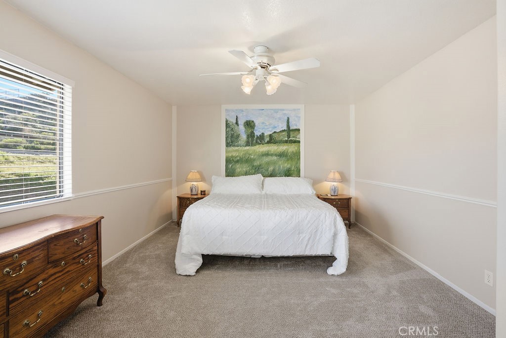 2680 Kashmere Canyon Road Acton, CA 93510 - Photo 27 of 60 a bedroom with a bed and a chandelier