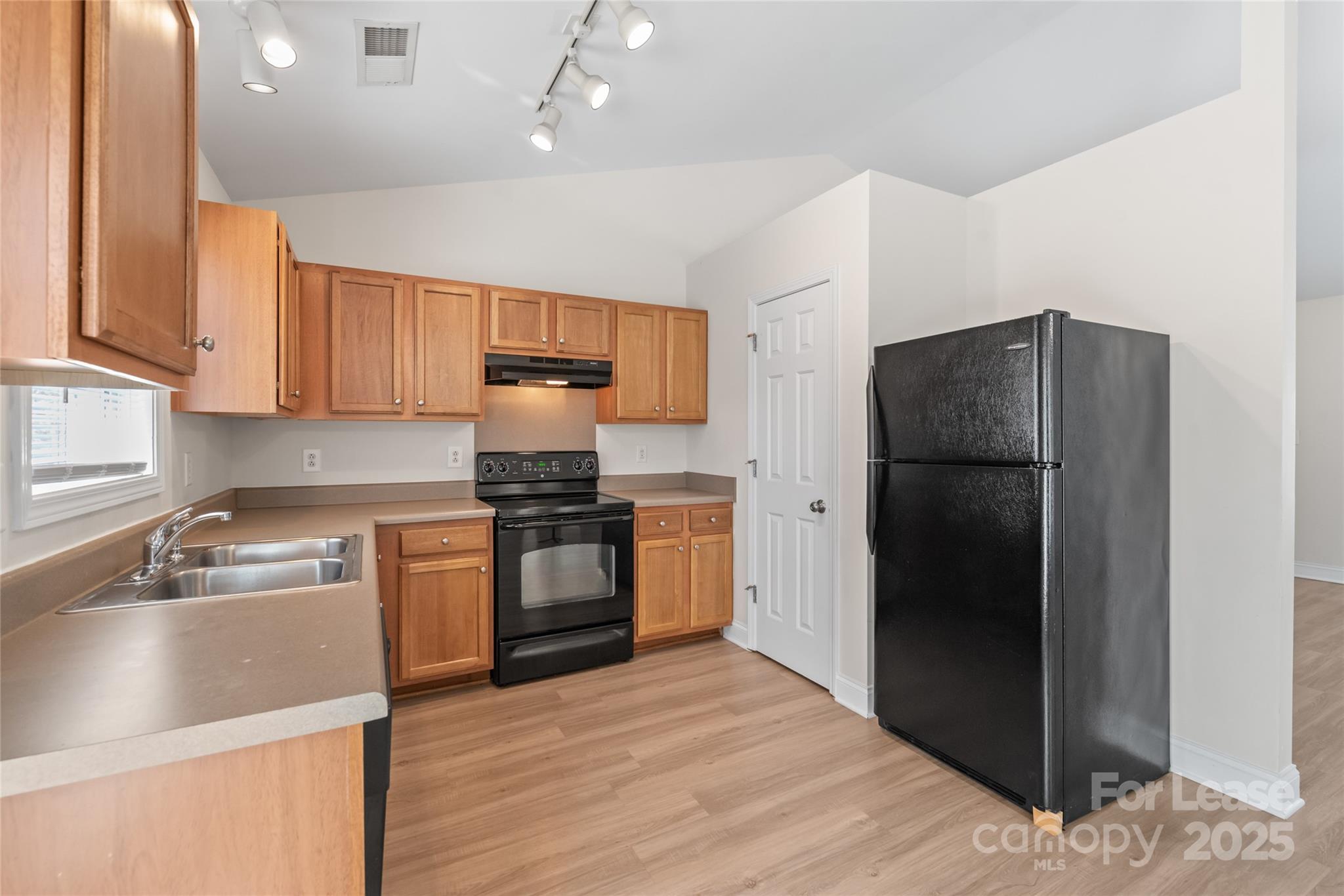 3007 Laurel Creek Lane Monroe, NC 28110 - Photo 11 of 28 a kitchen with a refrigerator and a sink