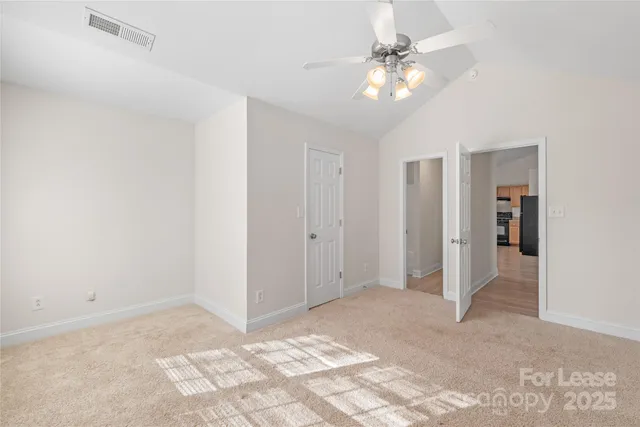 a view of a livingroom with a ceiling fan and a chandelier fan
