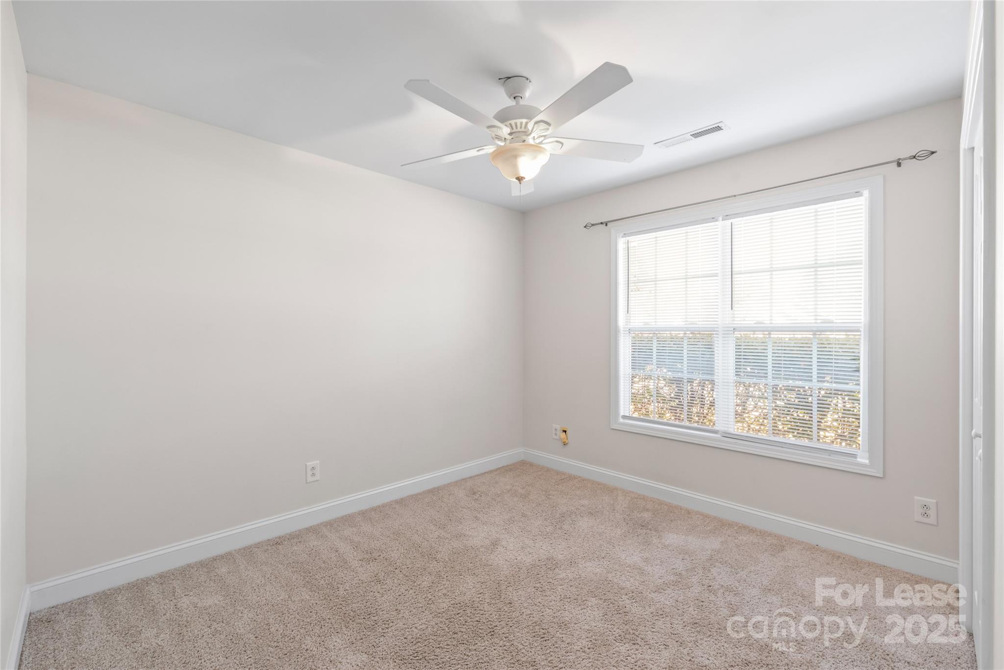 3007 Laurel Creek Lane Monroe, NC 28110 - Photo 20 of 28 an empty room with a window and a fan