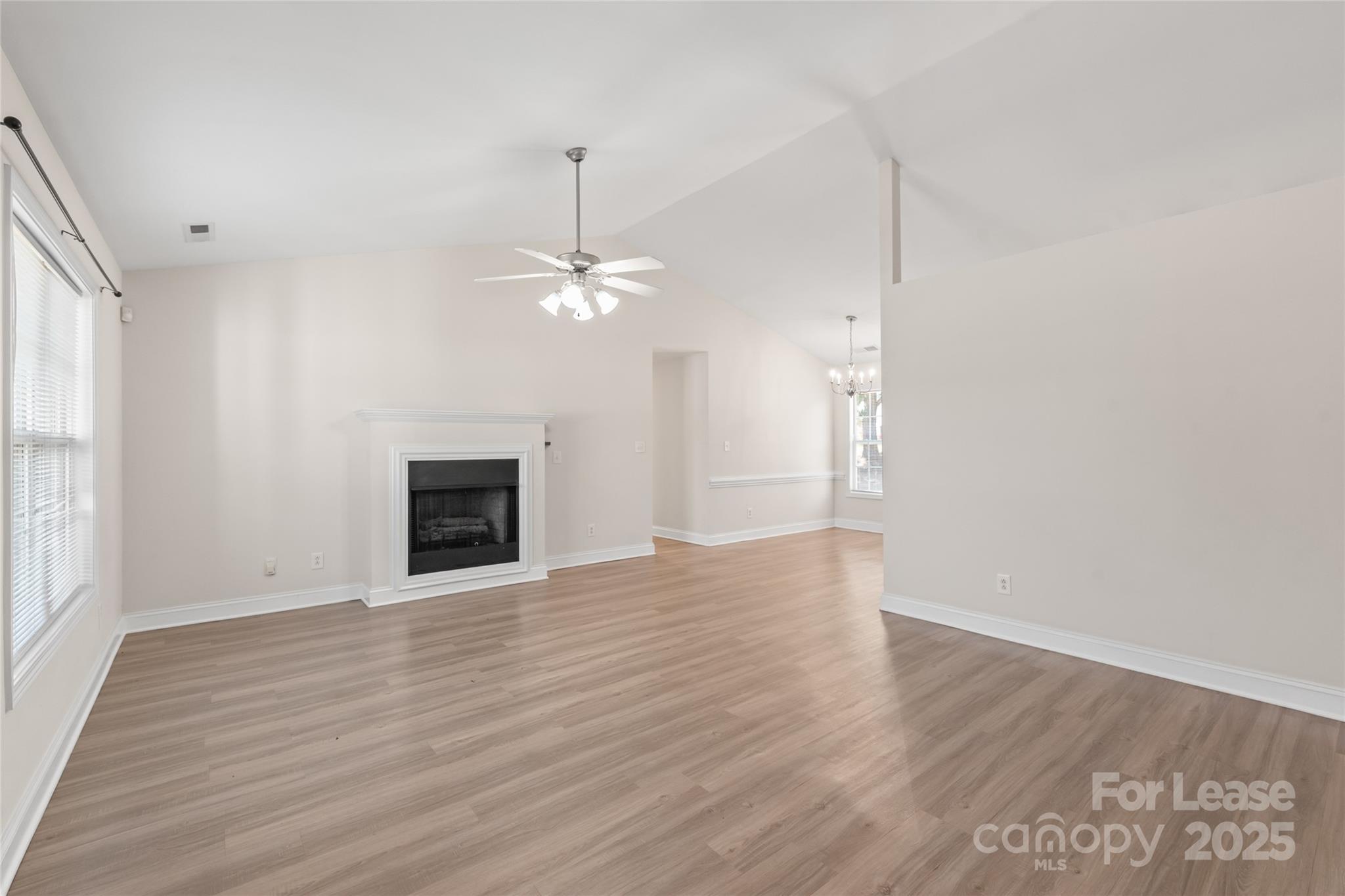 3007 Laurel Creek Lane Monroe, NC 28110 - Photo 3 of 28 a view of an empty room with wooden floor and a window
