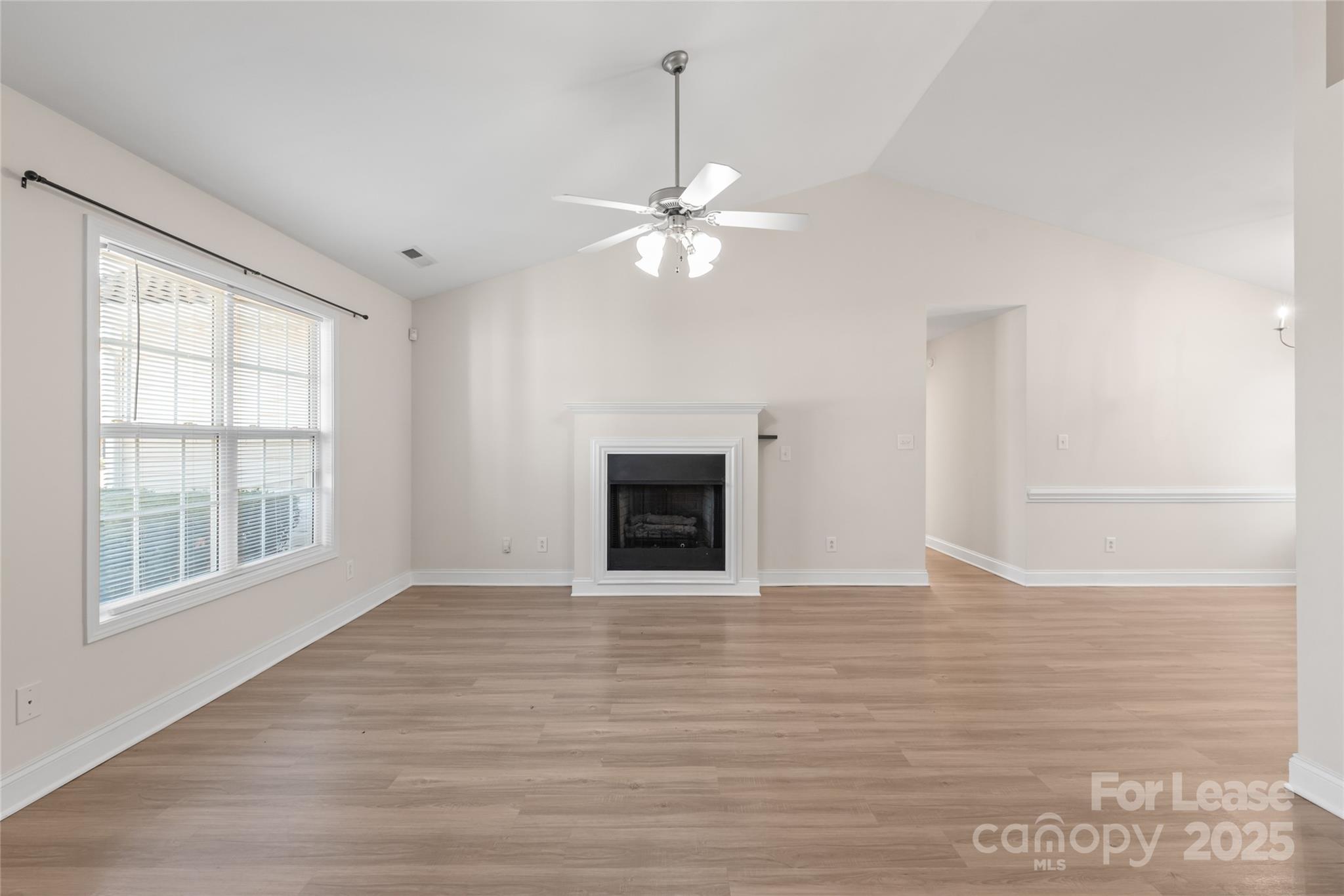 3007 Laurel Creek Lane Monroe, NC 28110 - Photo 5 of 28 a view of an empty room with a window and a kitchen