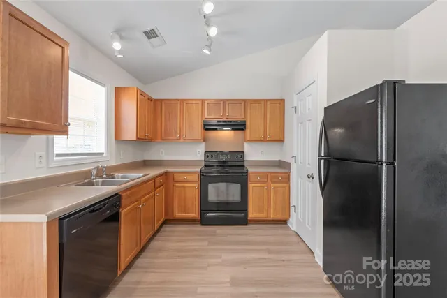 a kitchen with a refrigerator and a sink