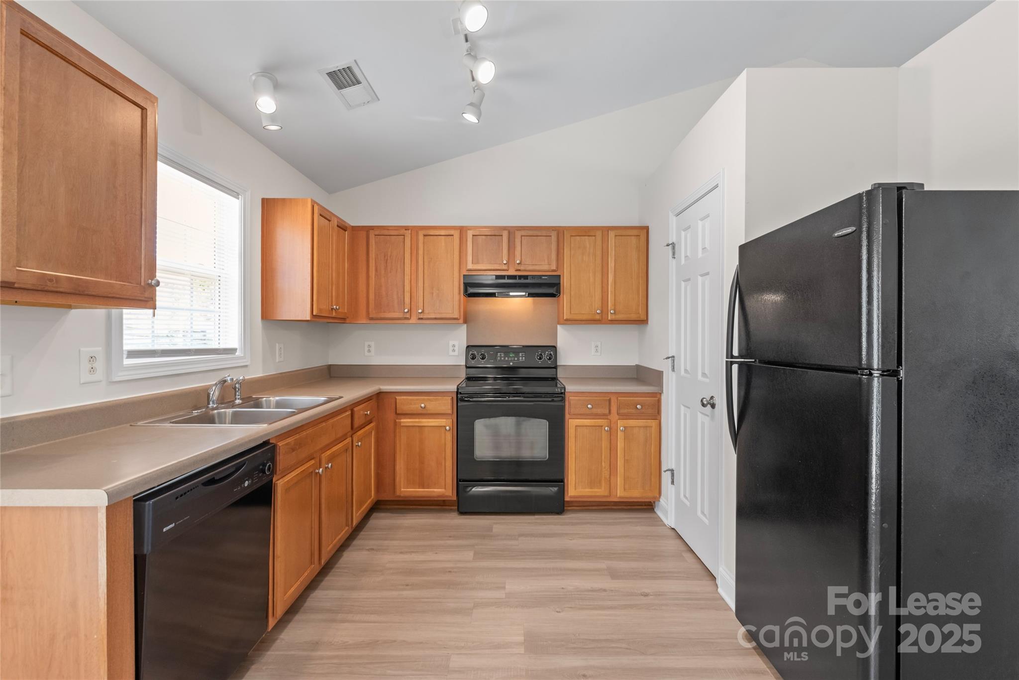 3007 Laurel Creek Lane Monroe, NC 28110 - Photo 10 of 28 a kitchen with a refrigerator and a sink
