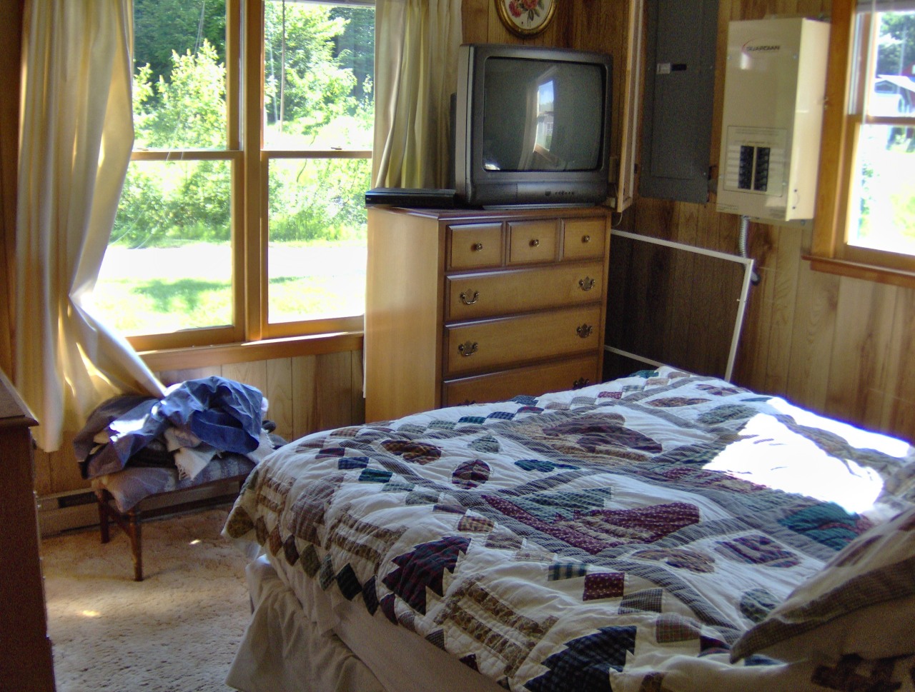 92 Access Road 3 Road, Unit 3 Plainfield, MA 01070 - Photo 16 of 19 a bedroom with a bed and flat screen tv