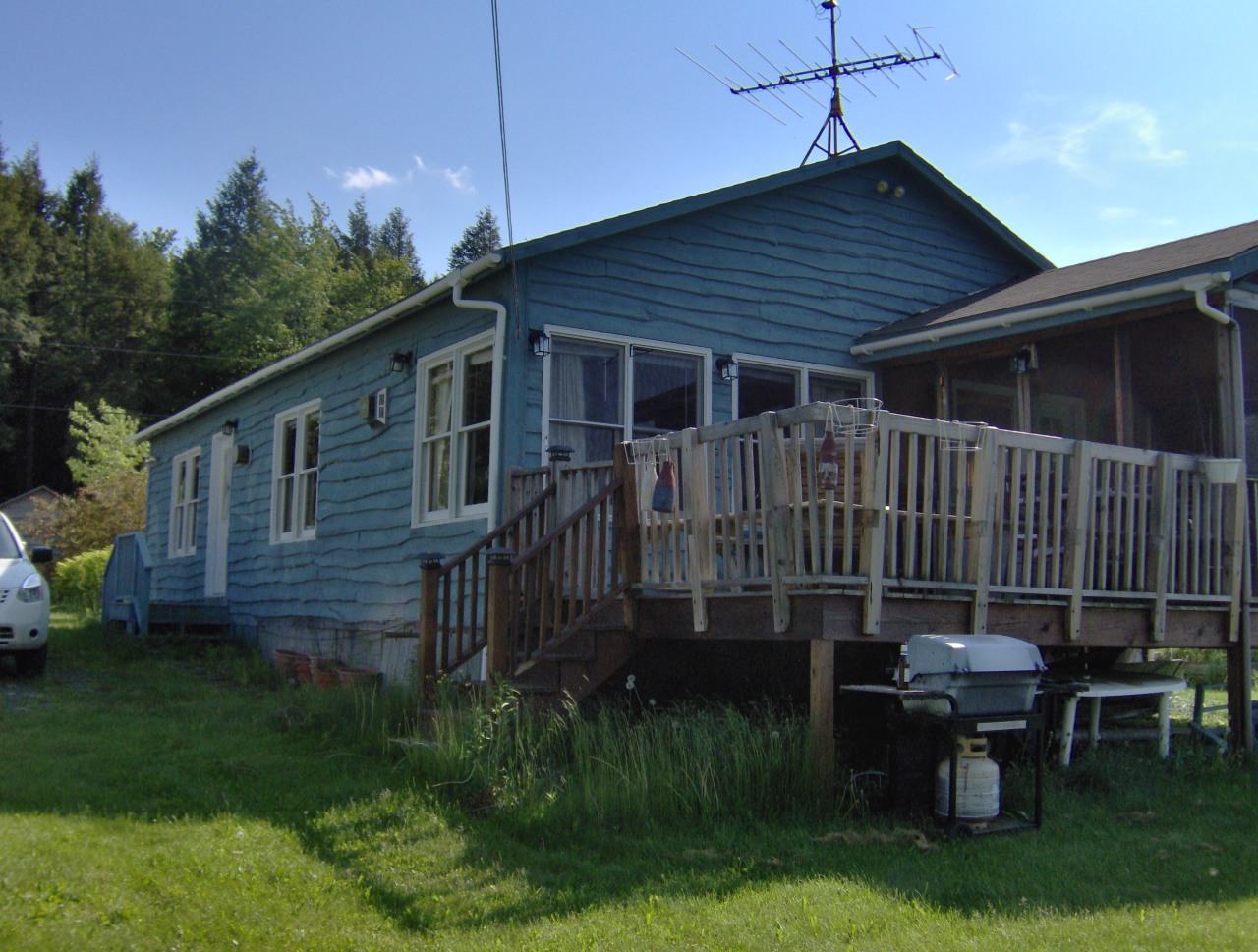 92 Access Road 3 Road, Unit 3 Plainfield, MA 01070 - Photo 17 of 19 a backyard of a house with a garden and deck