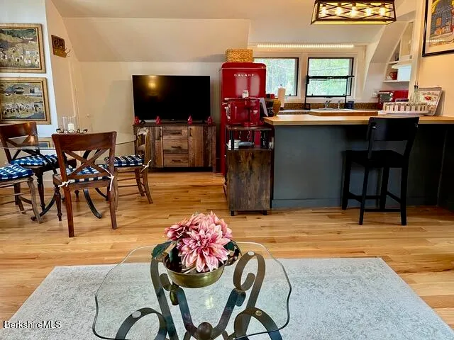 a view of a dining room with furniture and wooden floor
