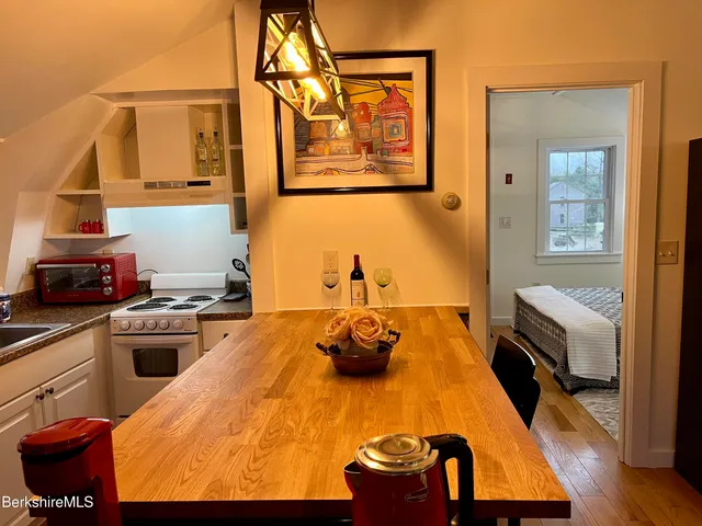 a kitchen with wooden floor and stainless steel appliances