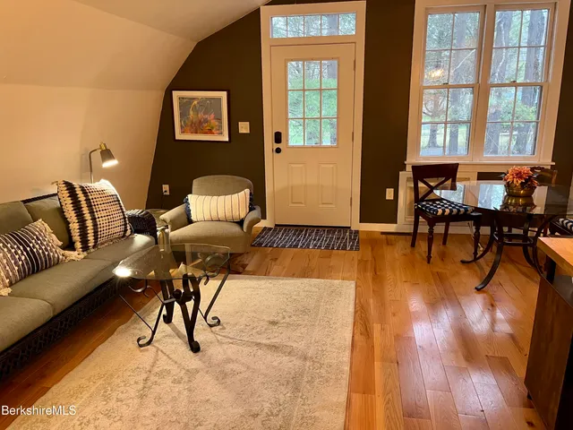 a living room with furniture and a floor to ceiling window