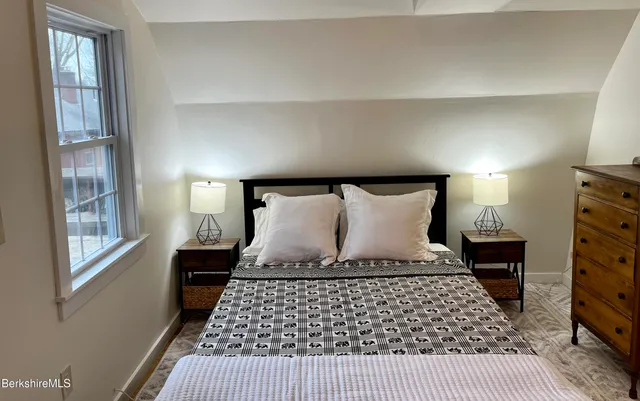 a bedroom with a large bed and a window