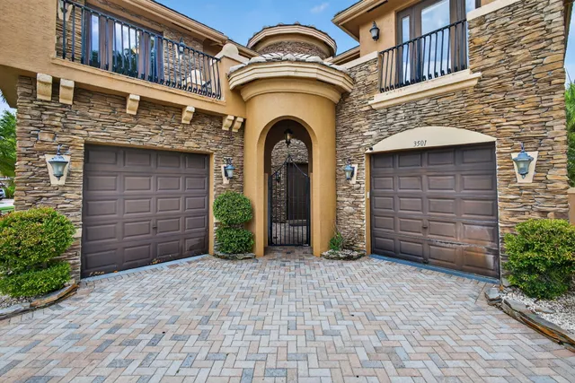 a kitchen with stainless steel appliances granite countertop a sink stove refrigerator and cabinets