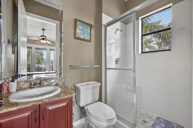 a large spacious bathroom with a granite countertop tub mirror and window