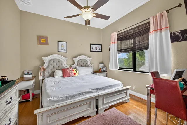 a spacious bathroom with a granite countertop tub a double vanity sink a window and a mirror