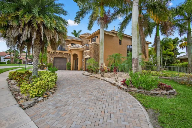 an aerial view of a house with swimming pool and garden view
