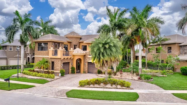 an aerial view of a house with outdoor space and swimming pool