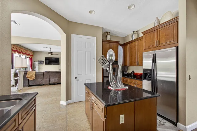 a living room with furniture ceiling fan and a large window