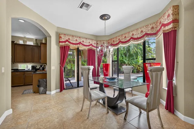 a living room with furniture gym equipment and a large window