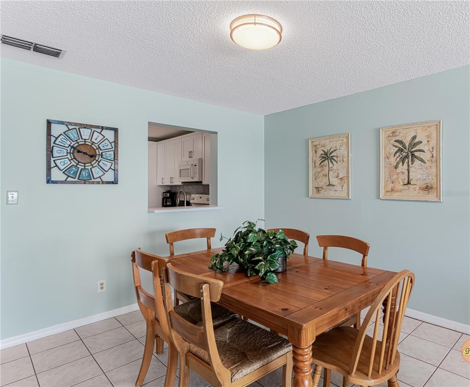 13500 Gulf Boulevard, Unit 602 Madeira Beach, FL 33708 - Photo 11 of 34 a view of a dining room with furniture
