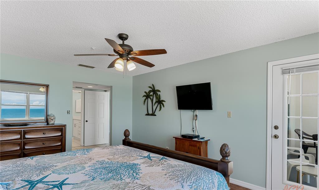 13500 Gulf Boulevard, Unit 602 Madeira Beach, FL 33708 - Photo 20 of 34 a bedroom with furniture and a window