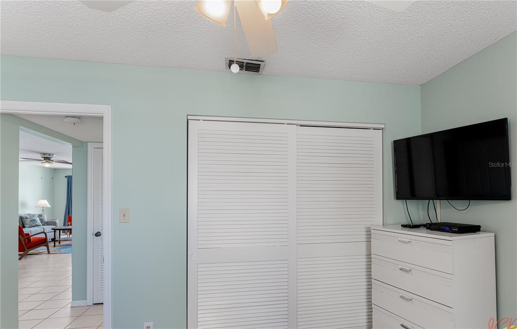 13500 Gulf Boulevard, Unit 602 Madeira Beach, FL 33708 - Photo 25 of 34 a view of a livingroom with an empty space and a flat screen tv