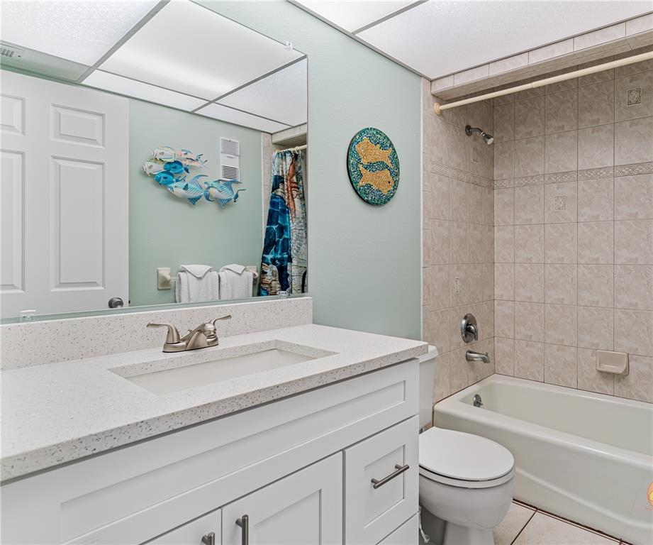 13500 Gulf Boulevard, Unit 602 Madeira Beach, FL 33708 - Photo 26 of 34 a bathroom with a sink a toilet and a bathtub