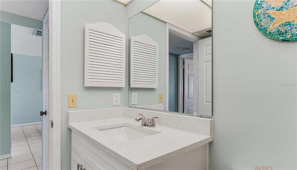13500 Gulf Boulevard, Unit 602 Madeira Beach, FL 33708 - Photo 27 of 34 a bathroom with a sink and a mirror