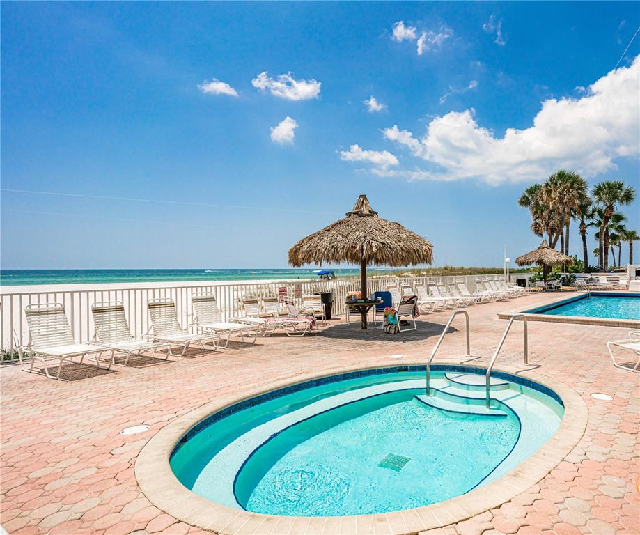 13500 Gulf Boulevard, Unit 602 Madeira Beach, FL 33708 - Photo 29 of 34 a view of a swimming pool with a patio