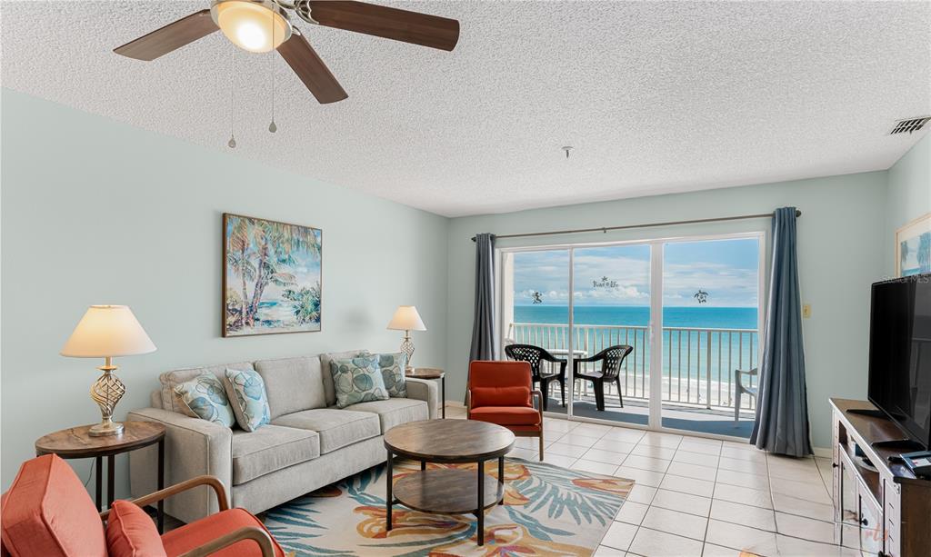 13500 Gulf Boulevard, Unit 602 Madeira Beach, FL 33708 - Photo 6 of 34 a living room with furniture and a flat screen tv