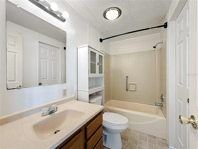 a bathroom with a sink toilet a mirror and shower