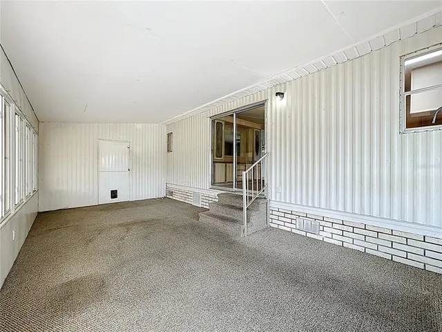 a view of an empty room with a fireplace