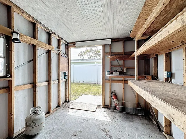 a view of kitchen with refrigerator and window