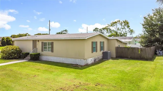 a view of a house with a yard and deck