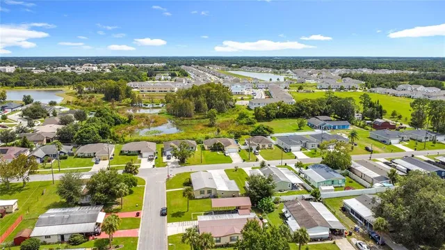 an aerial view of residential building and lake