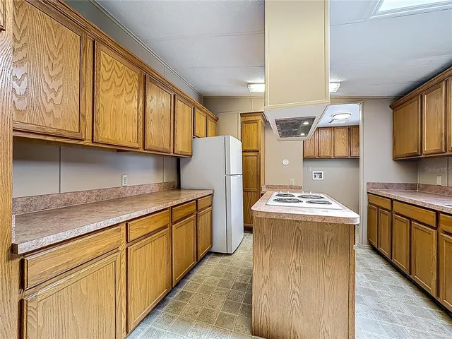 a kitchen with stainless steel appliances granite countertop wooden cabinets sink and stove top oven
