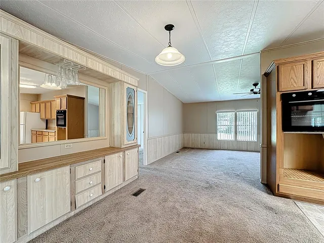 a view of an empty room with window and cabinet
