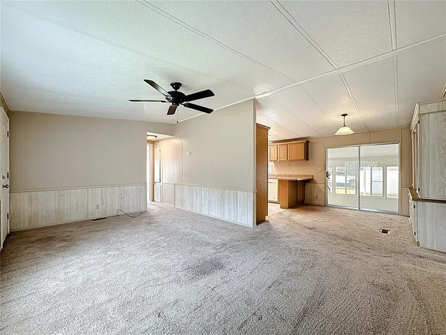 a view of a livingroom with a ceiling fan and window