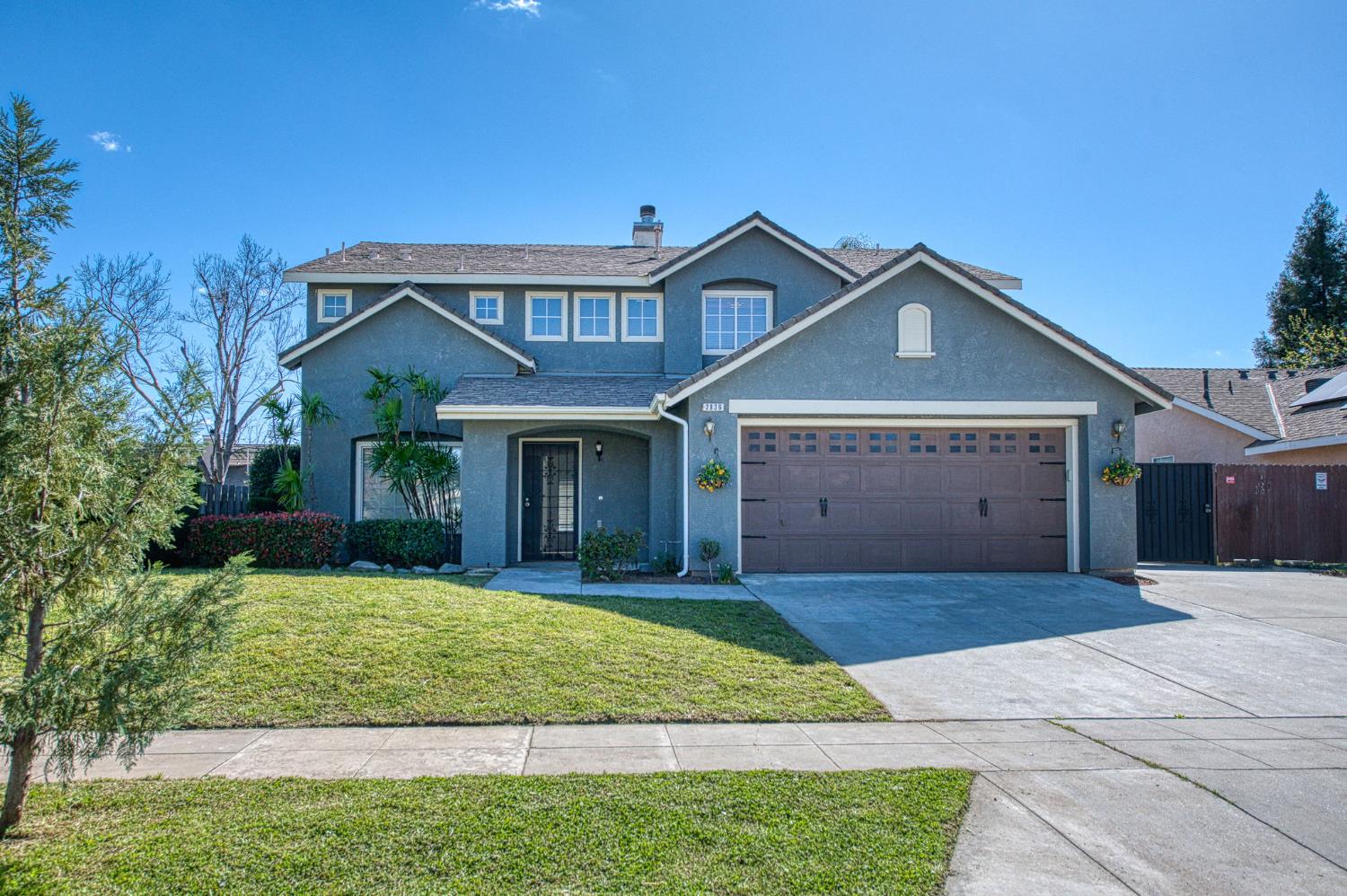 2836 Griffith Avenue Clovis, CA 93611 - Photo 1 of 41 a front view of a house with a yard and garage