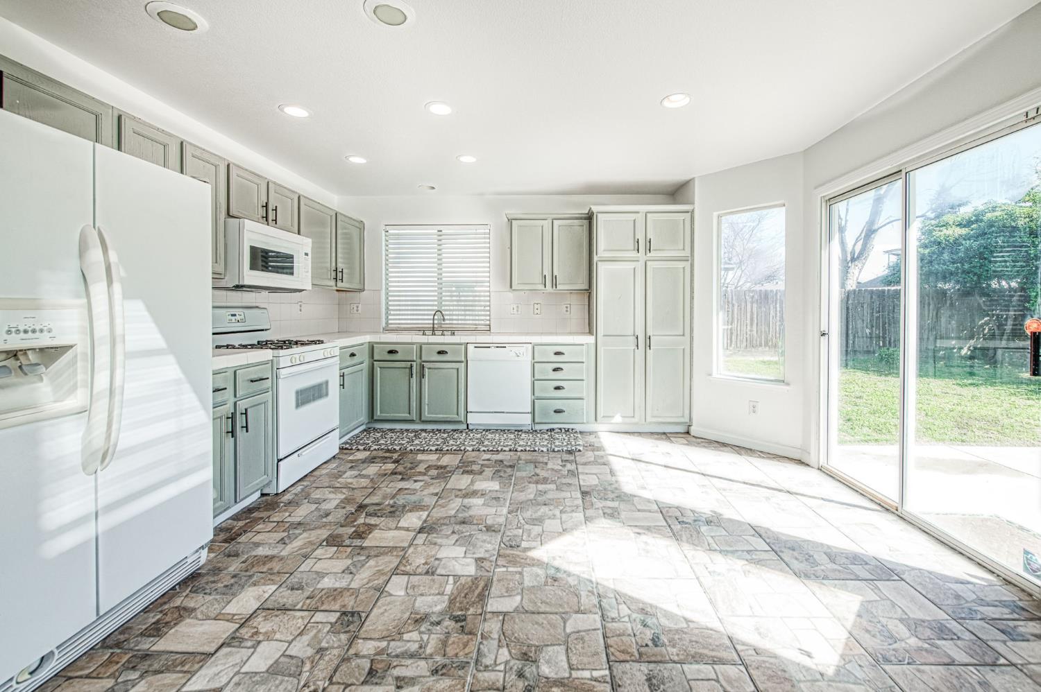 2836 Griffith Avenue Clovis, CA 93611 - Photo 14 of 41 a large kitchen with cabinets and wooden floor