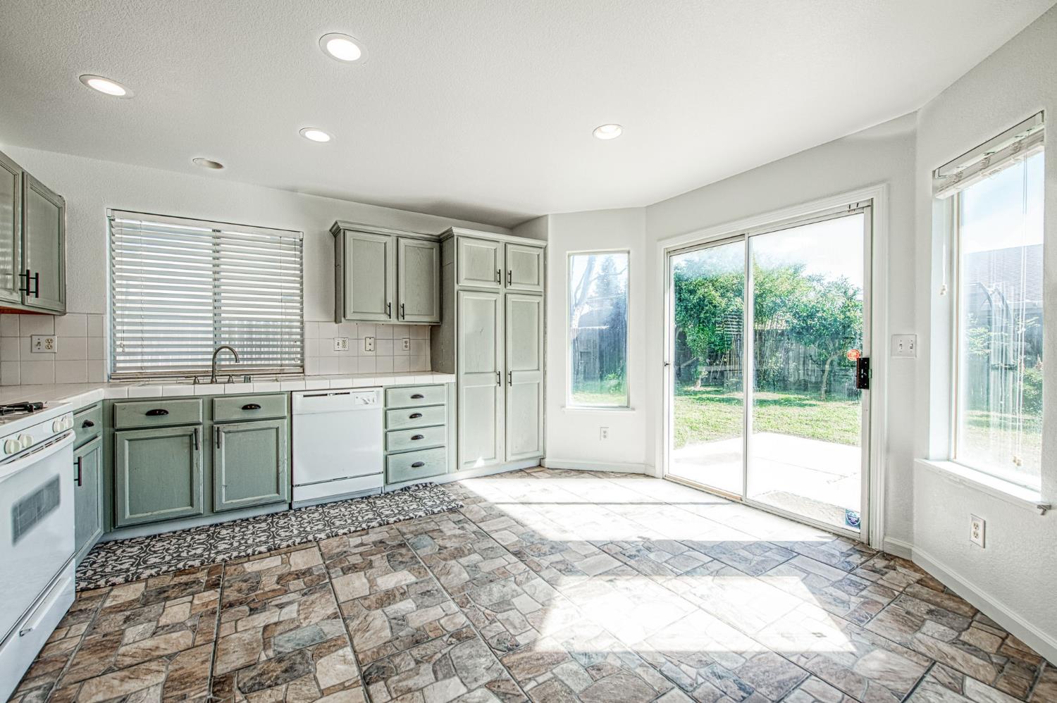 2836 Griffith Avenue Clovis, CA 93611 - Photo 15 of 41 a spacious bathroom with a granite countertop sink and a large mirror