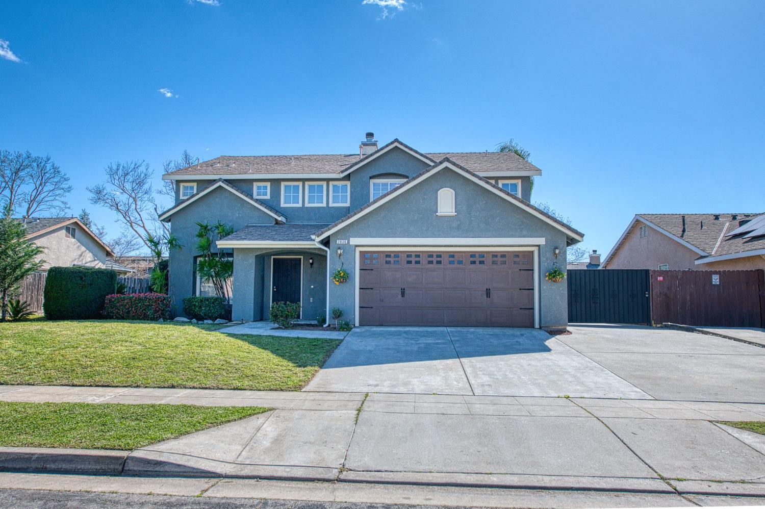 2836 Griffith Avenue Clovis, CA 93611 - Photo 2 of 41 a front view of a house with a yard and garage