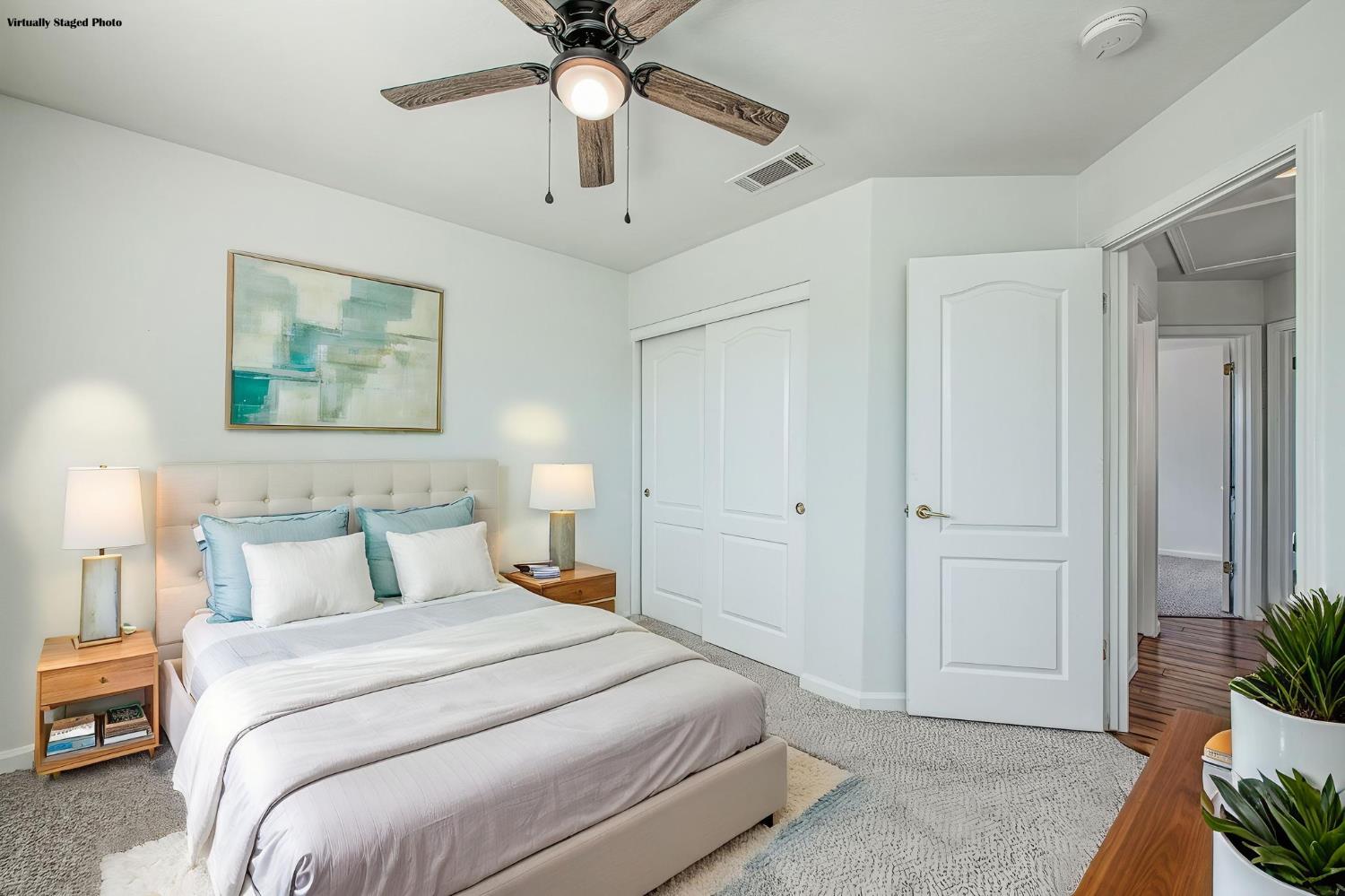 2836 Griffith Avenue Clovis, CA 93611 - Photo 24 of 41 a bedroom with a large bed and a chandelier