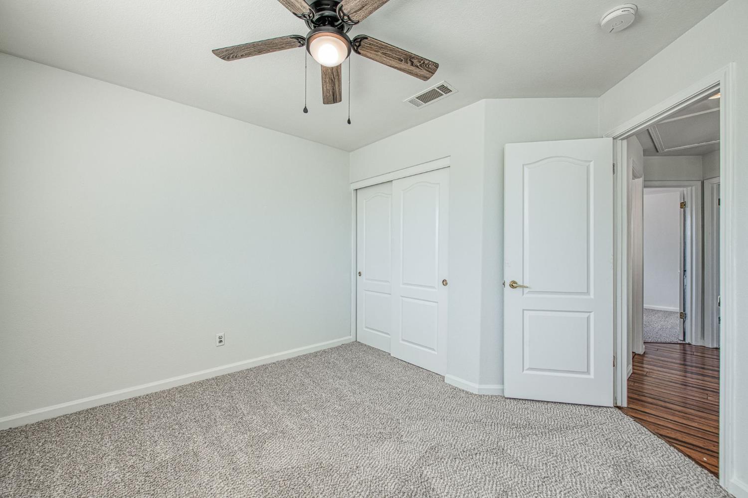 2836 Griffith Avenue Clovis, CA 93611 - Photo 25 of 41 an empty room with a ceiling fan and a window