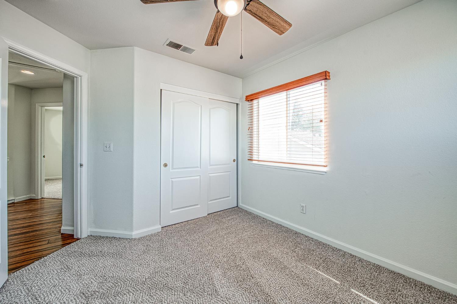 2836 Griffith Avenue Clovis, CA 93611 - Photo 26 of 41 an empty room with a ceiling fan and a window