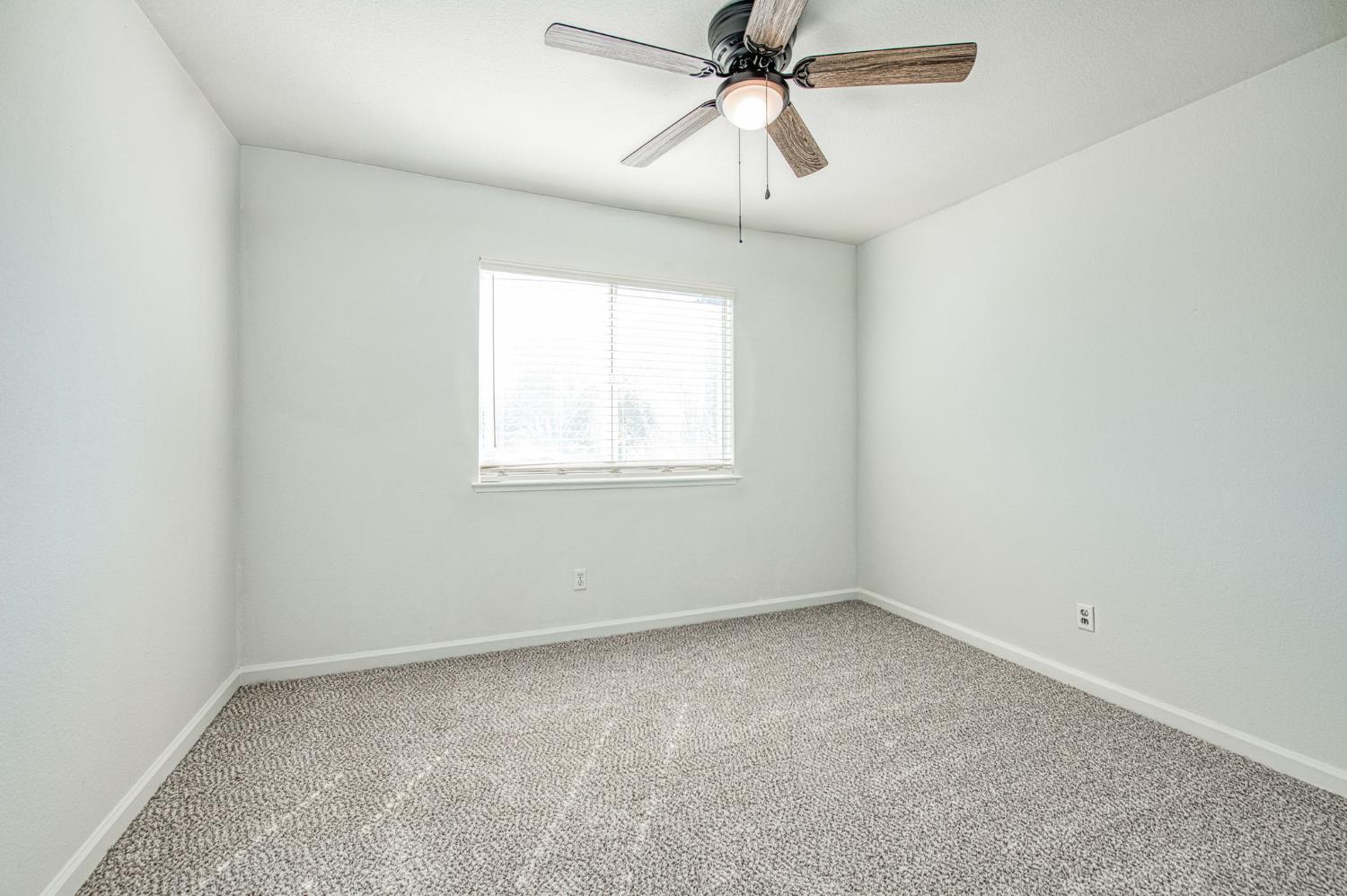 2836 Griffith Avenue Clovis, CA 93611 - Photo 27 of 41 an empty room with a window and a fan