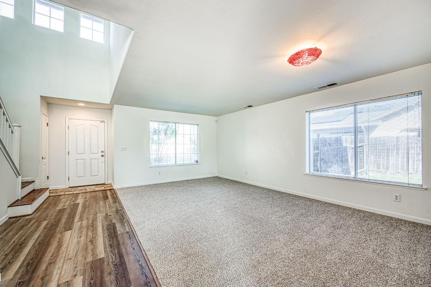 2836 Griffith Avenue Clovis, CA 93611 - Photo 9 of 41 a view of an empty room with wooden floor and a window