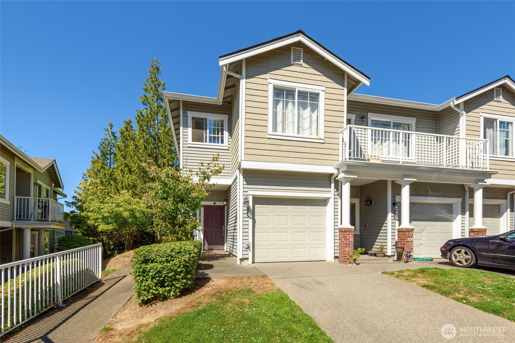 5001 Davis Place South, Unit A Renton, WA 98055 - Photo 1 of 24 a front view of a house with trees and plants