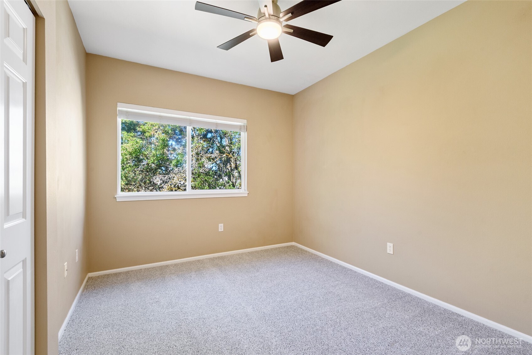 5001 Davis Place South, Unit A Renton, WA 98055 - Photo 16 of 24 an empty room with a window and a fan