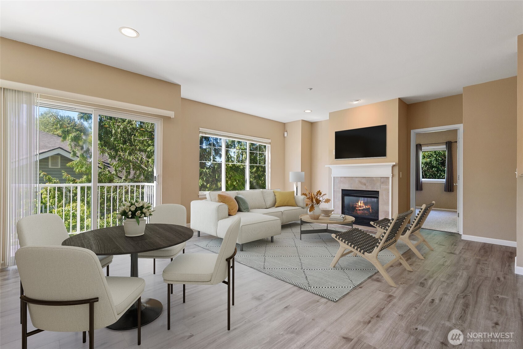 5001 Davis Place South, Unit A Renton, WA 98055 - Photo 4 of 24 a living room with furniture a fireplace and a floor to ceiling window