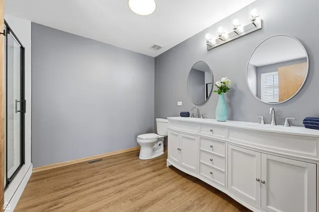 a spacious bathroom with a double vanity sink and a mirror