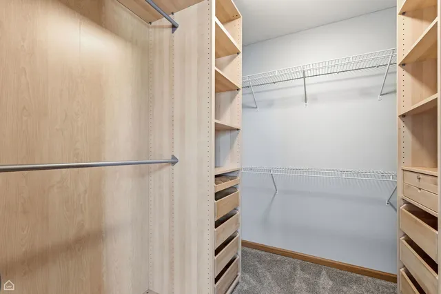 a view of walk in closet with empty racks